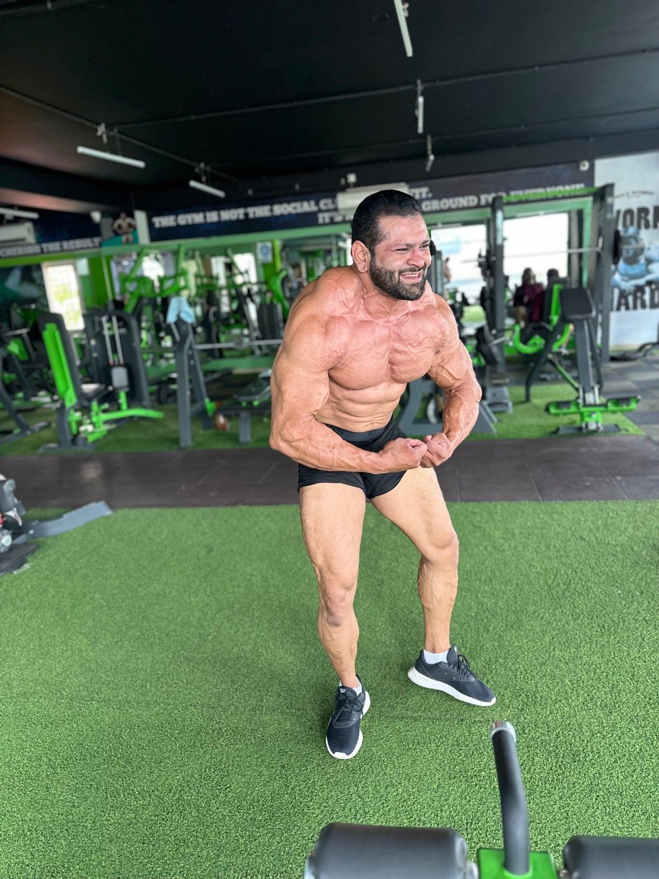 Bodybuilder posing on the Hulk Fitness training floor
